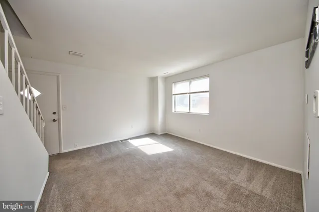 an empty room with windows & door