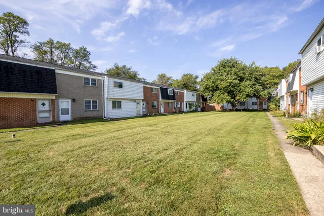 a view of a house with a garden and yard