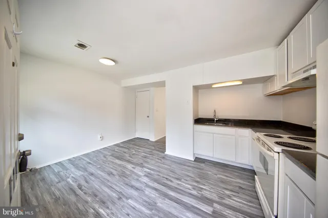 a kitchen with granite countertop a stove and a sink