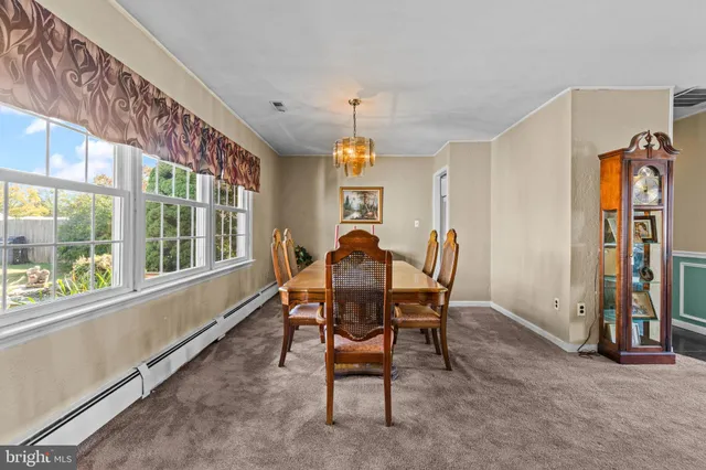a dining room with furniture a chandelier and a rug