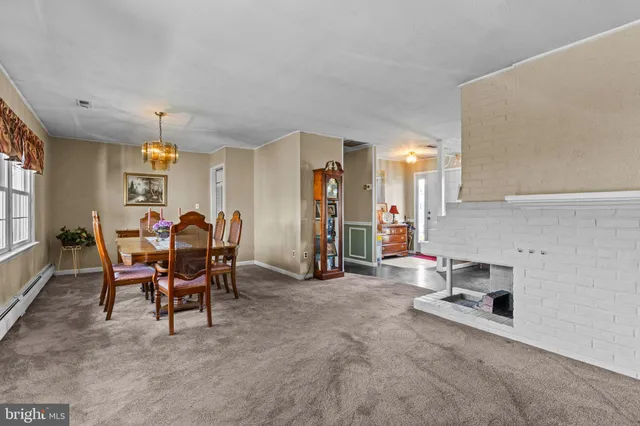 a view of a dining room with furniture and a chandelier