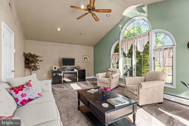 a living room with furniture fireplace and flat screen tv