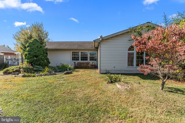 a view of a house with a yard and sitting area