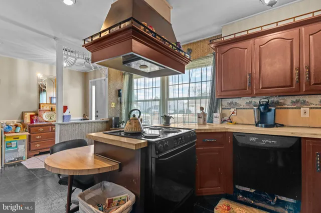 a kitchen with stainless steel appliances a sink stove and cabinets