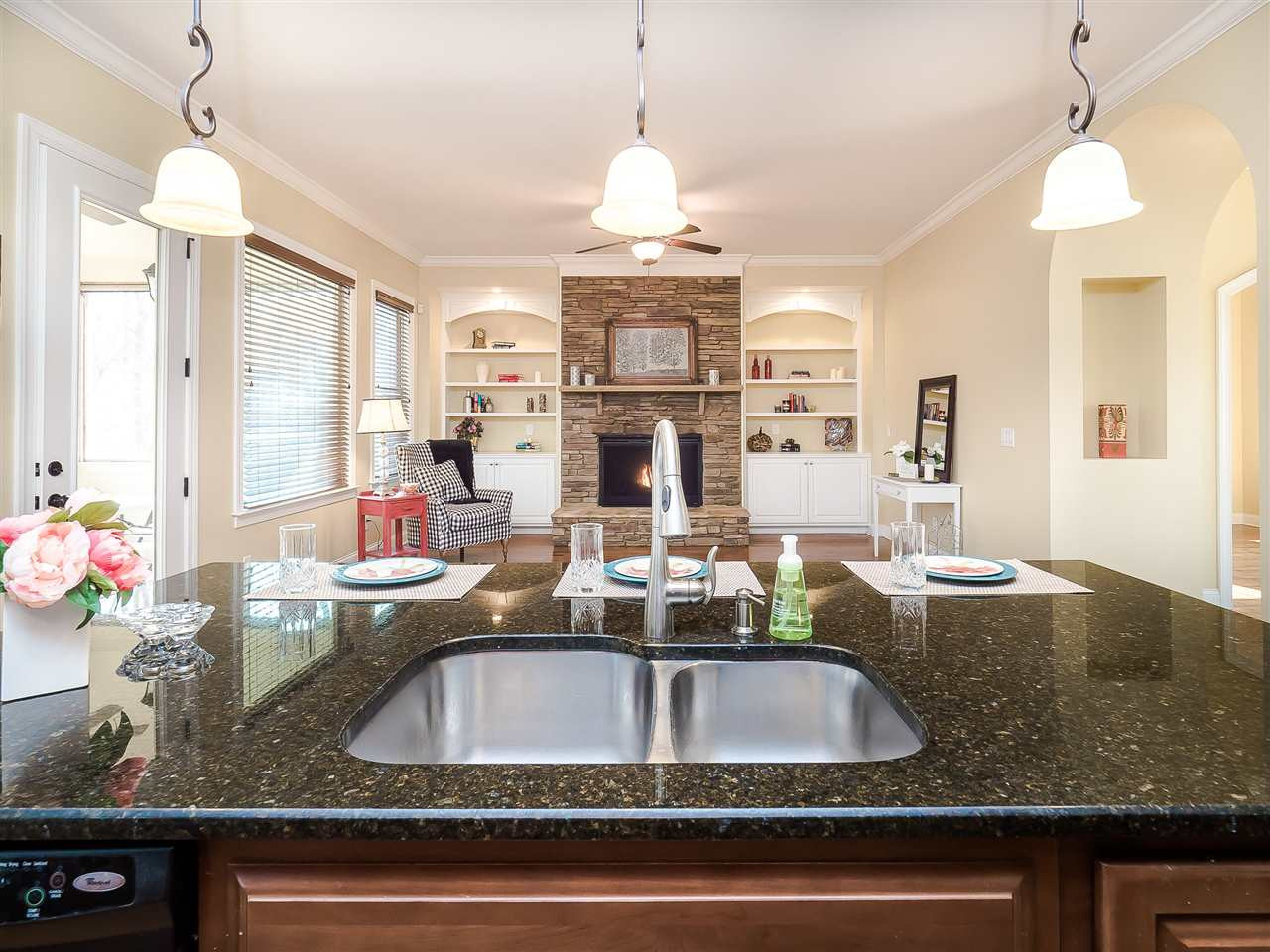 3004 Royal Forrest Drive Raleigh, NC 27614 - Photo 25 of 25 Open floor plan for easily entertaining your friends and family. Grab a stool for a quick sandwich at this large island. Pendant and spot lights provides ample lighting. Screened porch is conveniently located to the left and formal areas to the right. Kitchen