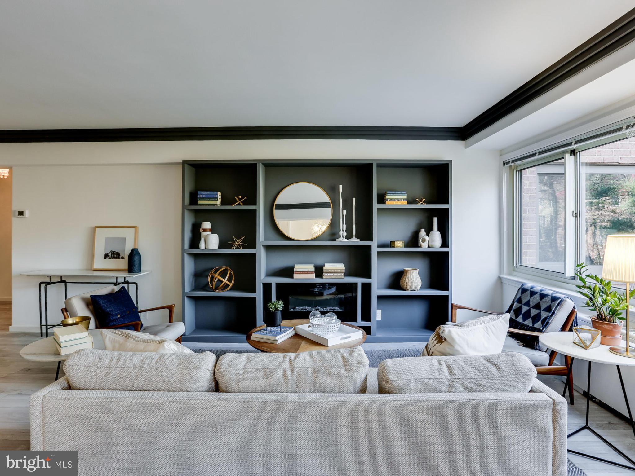 4201 Cathedral Avenue Northwest, Unit 703W Washington, DC 20016 - Photo 2 of 20 a living room with furniture and a fireplace