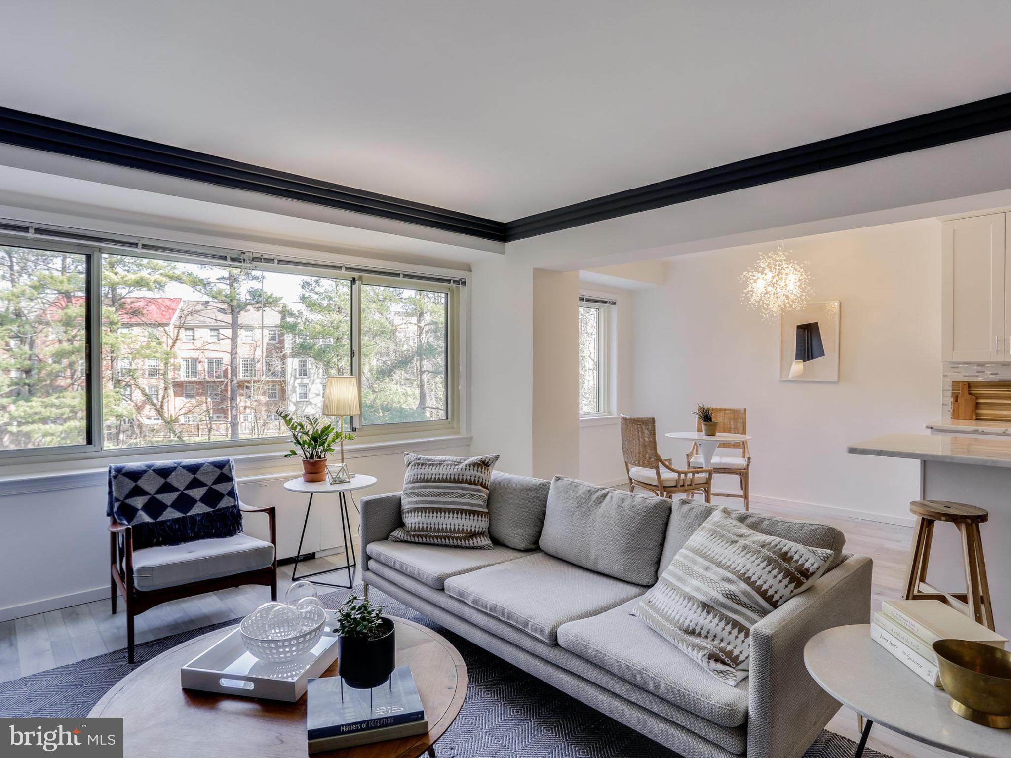 4201 Cathedral Avenue Northwest, Unit 703W Washington, DC 20016 - Photo 3 of 20 a living room with furniture and a large window
