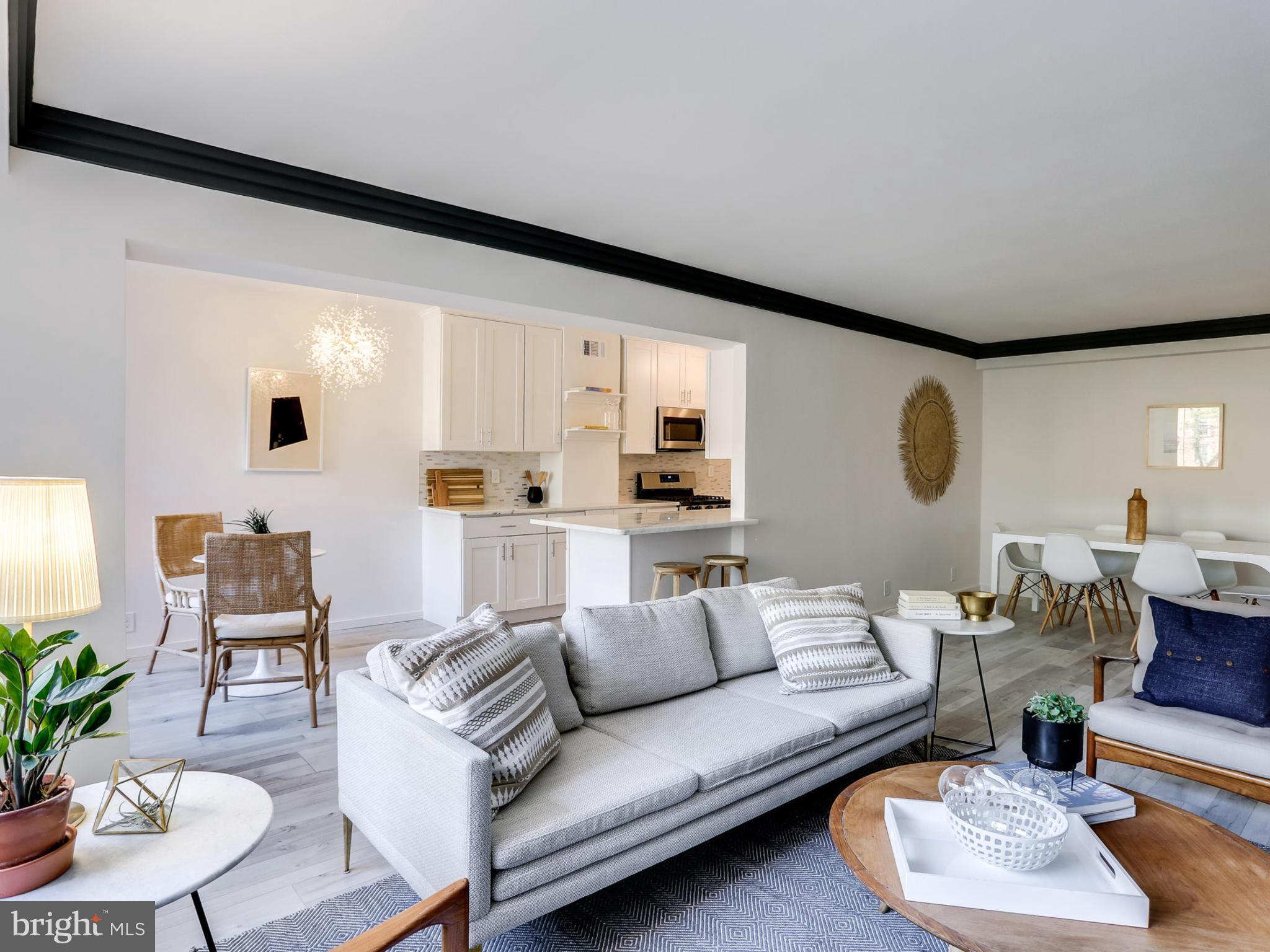 4201 Cathedral Avenue Northwest, Unit 703W Washington, DC 20016 - Photo 4 of 20 a living room with furniture and a large window