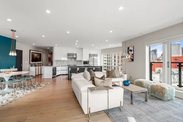 a living room with furniture and view of kitchen