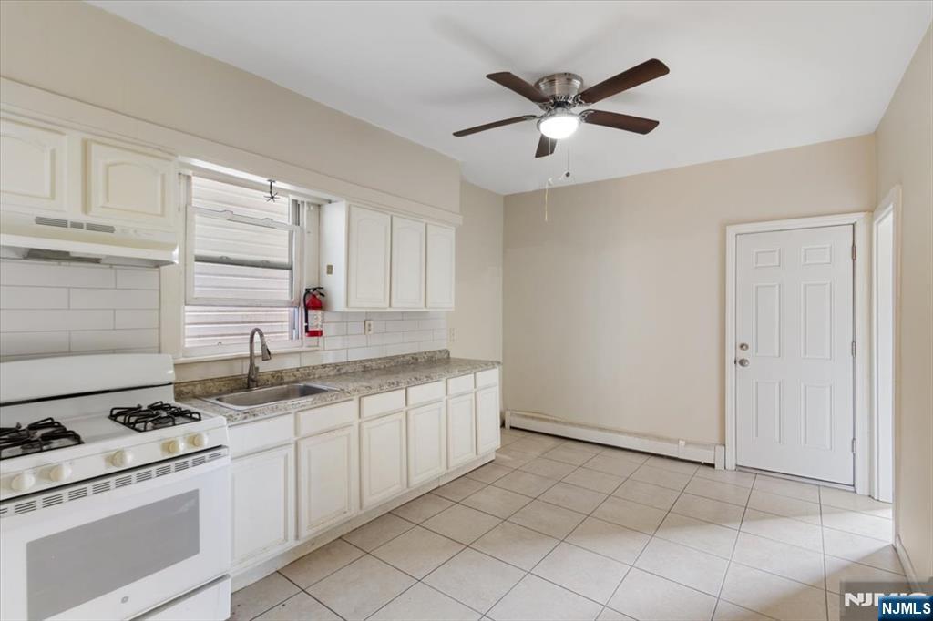 422 Jelliff Avenue, Unit 1 Newark, NJ 07112 - Photo 11 of 14 a kitchen with stainless steel appliances granite countertop a sink and cabinets