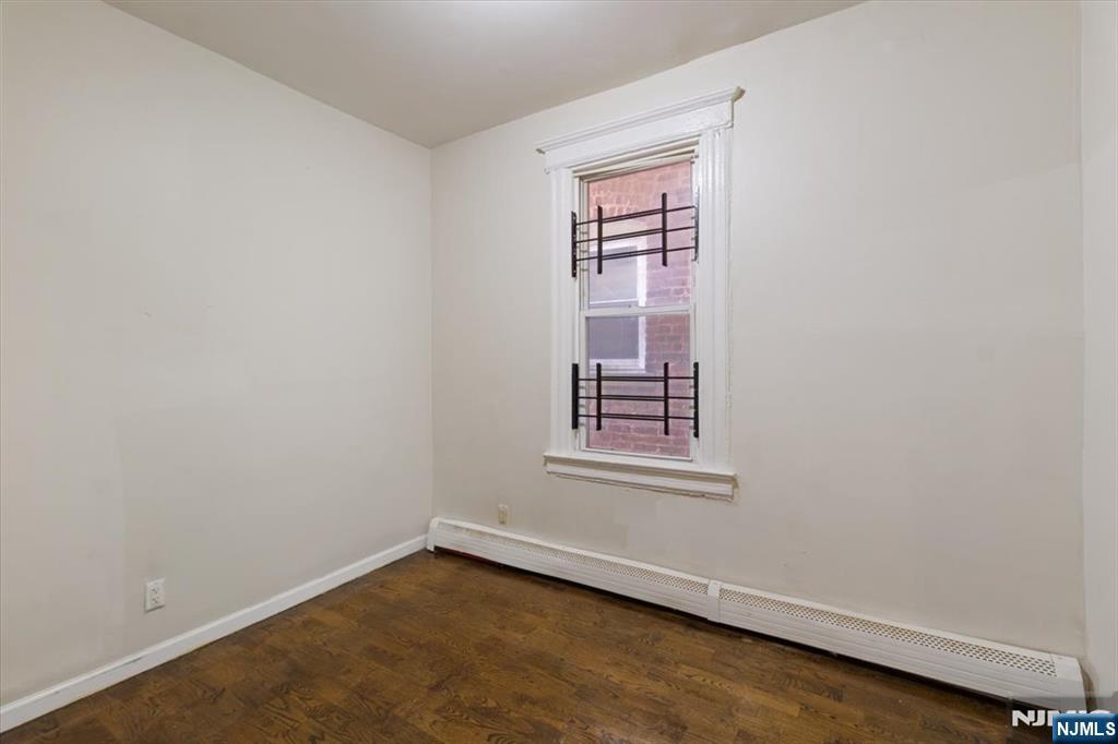 422 Jelliff Avenue, Unit 1 Newark, NJ 07112 - Photo 13 of 14 an empty room with windows
