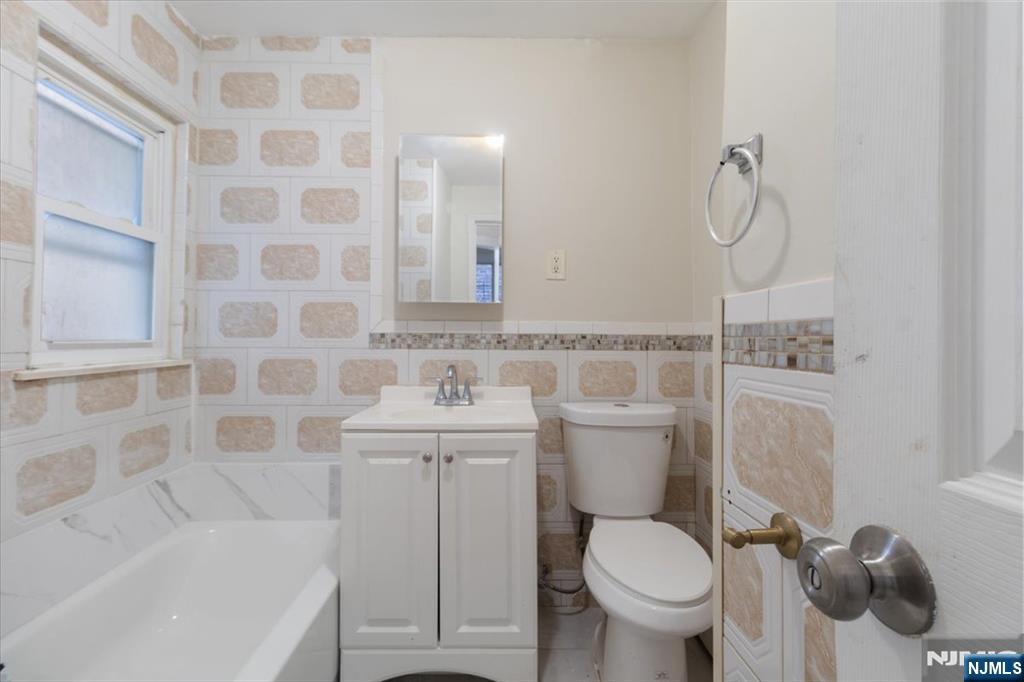422 Jelliff Avenue, Unit 1 Newark, NJ 07112 - Photo 7 of 14 a bathroom with a sink toilet and shower