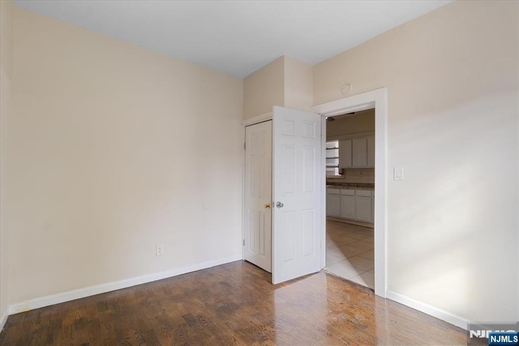422 Jelliff Avenue, Unit 1 Newark, NJ 07112 - Photo 8 of 14 an empty room with closet and a hallway