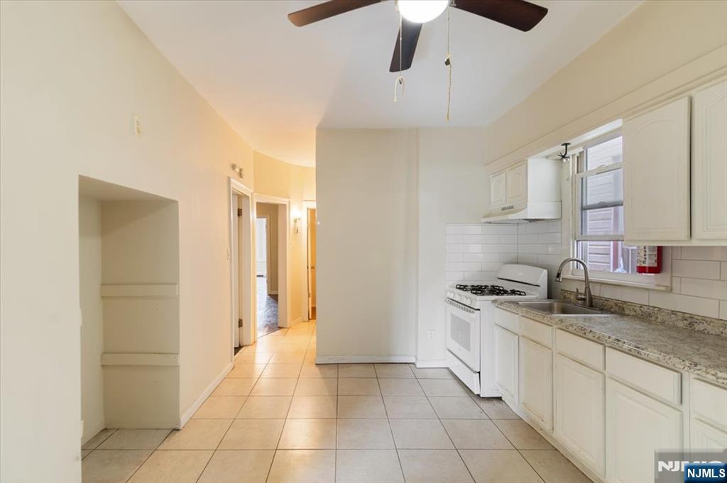 422 Jelliff Avenue, Unit 1 Newark, NJ 07112 - Photo 10 of 14 a kitchen with stainless steel appliances granite countertop a sink and cabinets