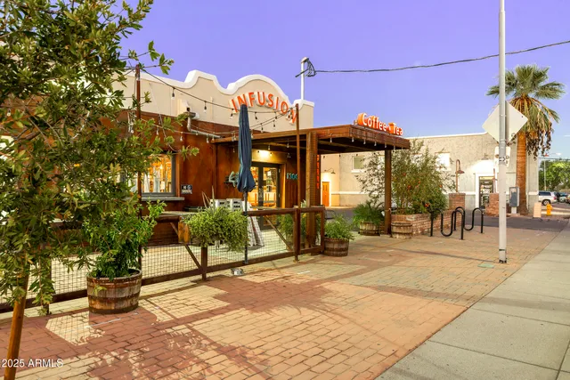 a front view of multiple houses with yard