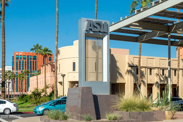 a front view of a building with parking area