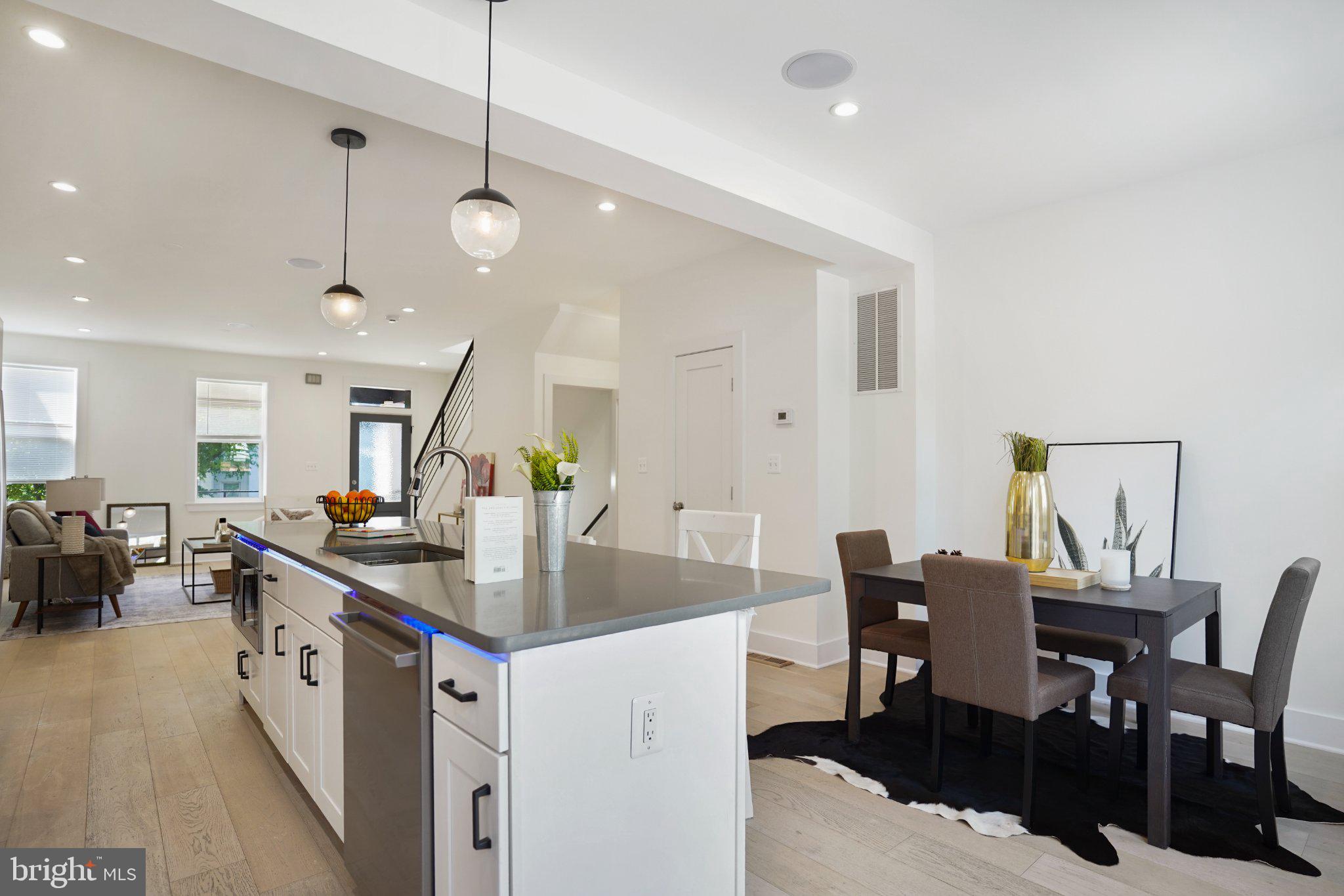 112 V Street Northeast Washington, DC 20002 - Photo 3 of 25 a kitchen with center island table and chairs