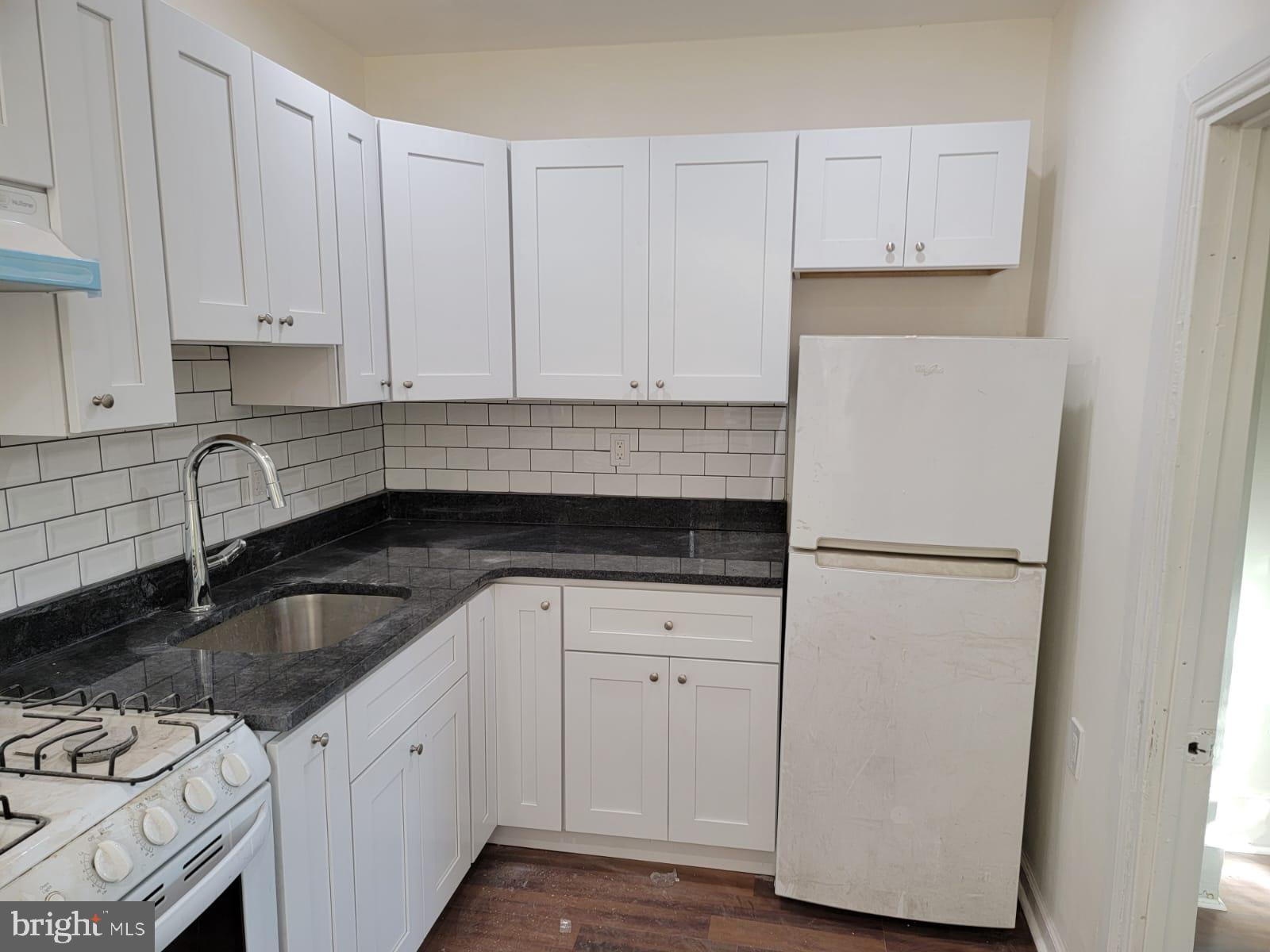 616 Tasker Street, Unit 2 Philadelphia, PA 19148 - Photo 4 of 22 a kitchen with a sink and white cabinets
