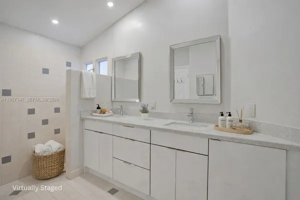 a bathroom with a granite countertop sink toilet and a mirror