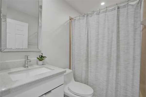 a view of a kitchen with a sink and chandelier