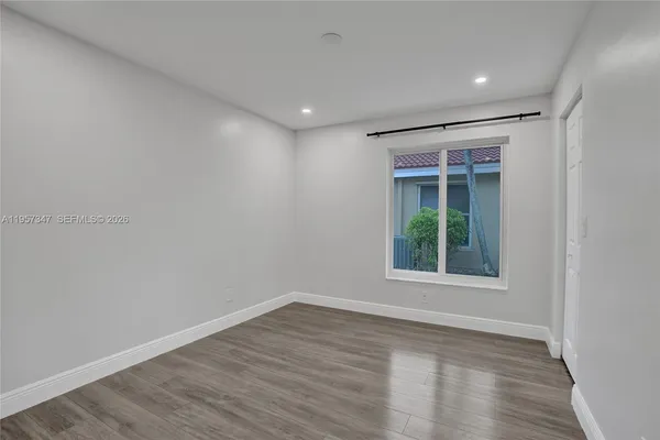 a large white kitchen with white cabinets