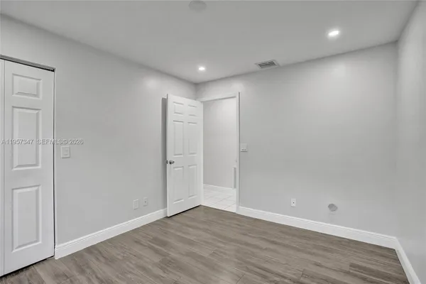 a kitchen with granite countertop a sink stove and refrigerator