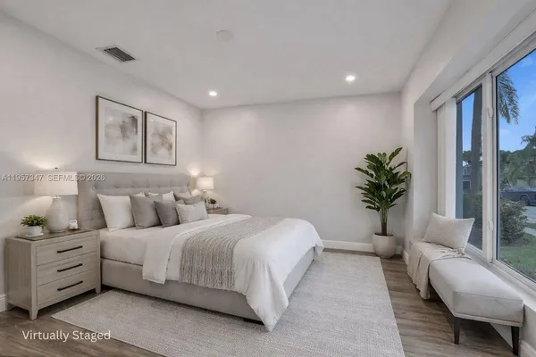 a bedroom with a bed and glass door