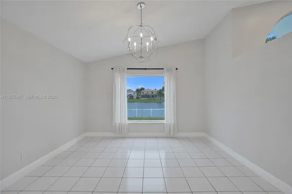 a front view of a house with garden and parking