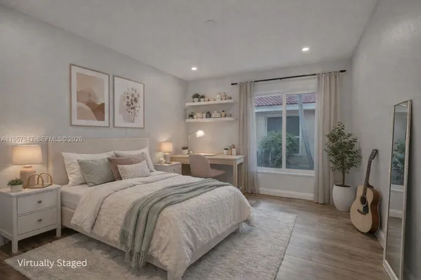 a living room with stainless steel appliances kitchen island granite countertop furniture and a couch