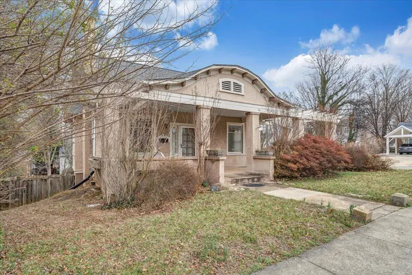 a view of a brick house with a yard