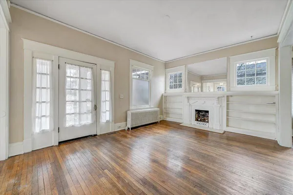 a view of a livingroom with wooden floors and fireplace
