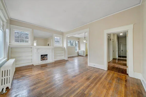 a view of empty room with wooden floor