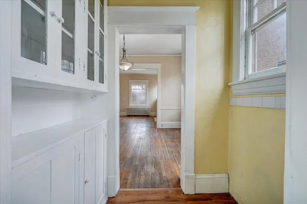 a view of kitchen with wooden floor and window