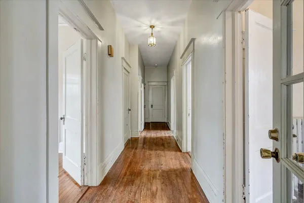 a view of a room with wooden floor closet and a window