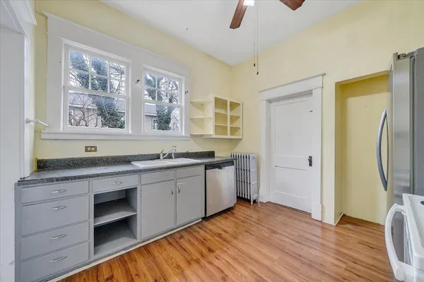 a spacious bathroom with a granite countertop sink a mirror and a bathtub