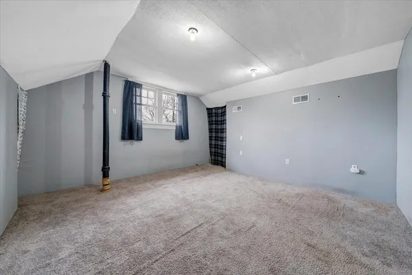 a view of a room with wooden ceiling