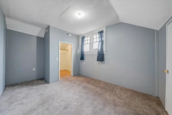 a bathroom with a granite countertop toilet sink and mirror