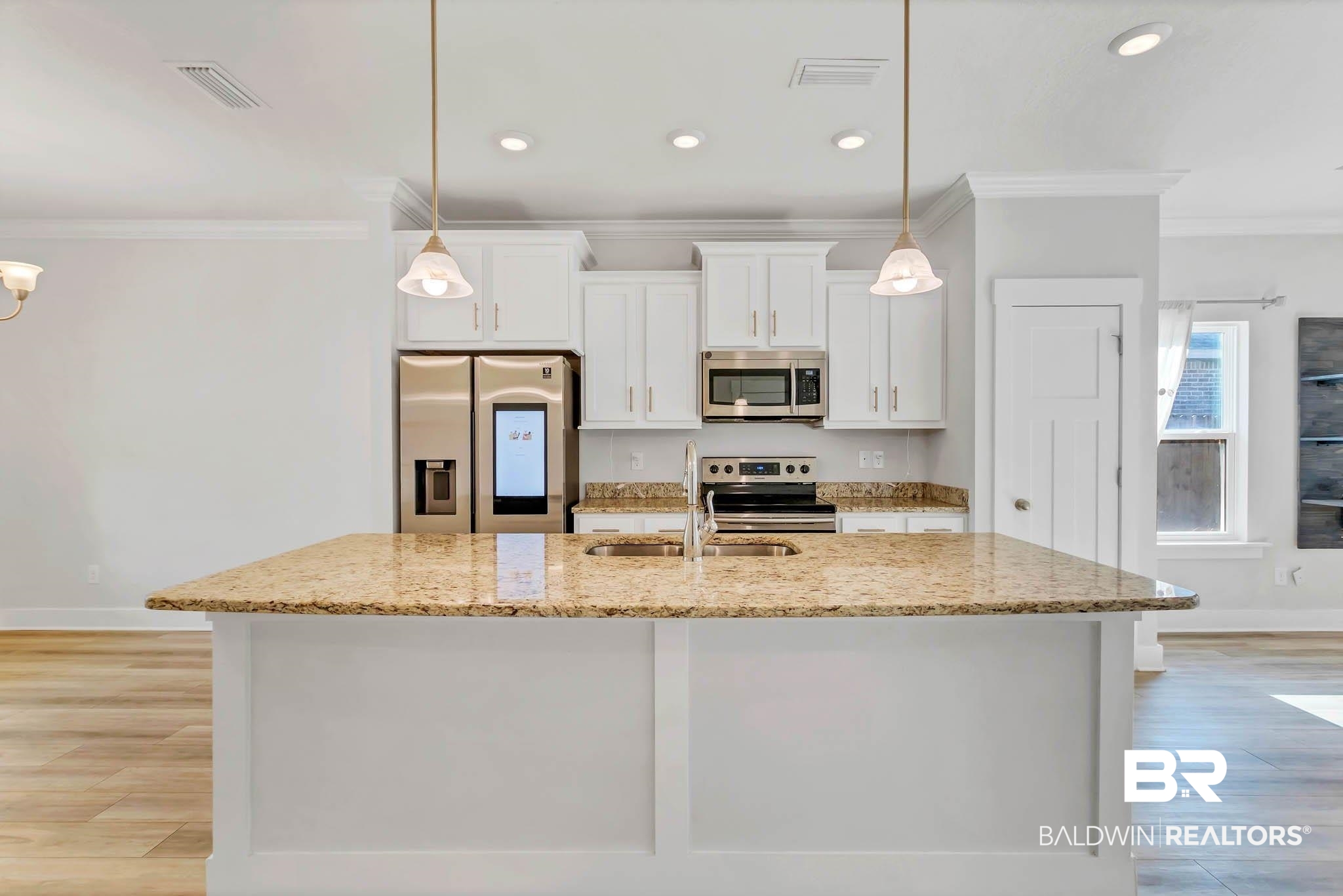 16461 Prado Loop Loxley, AL 36551 - Photo 6 of 78 Kitchen featuring ornamental molding, stainless steel appliances, white cabinets, light stone countertops, and light wood-type flooring