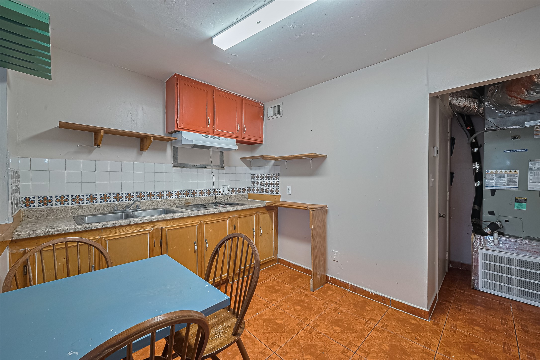 5012 Eigel Street Houston, TX 77007 - Photo 23 of 45 a kitchen with granite countertop a sink cabinets and window
