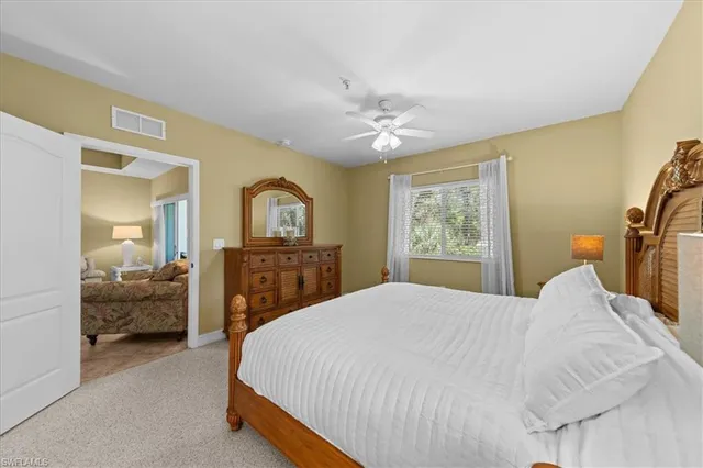 a bedroom with a bed and a ceiling fan
