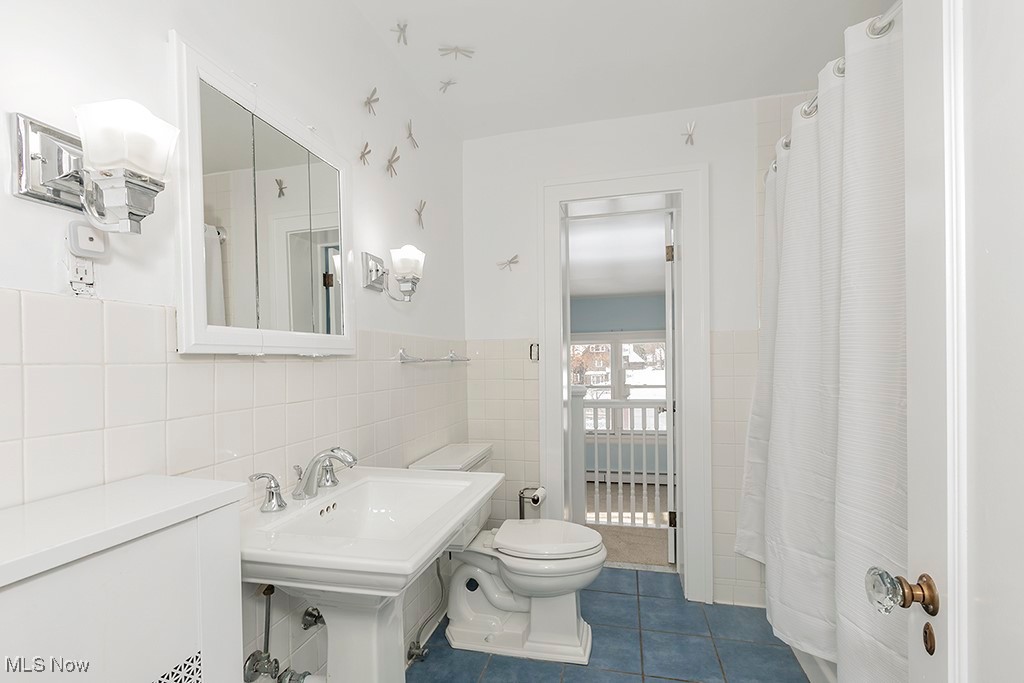 2596 Ashton Road Cleveland, OH 44118 - Photo 25 of 43 Bathroom with tile patterned flooring, tile walls, and toilet