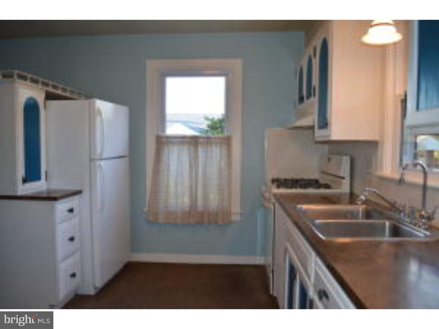 205 Old Fritztown Road Reading, PA 19607 - Photo 21 of 25 a kitchen with kitchen island a sink appliances and cabinets