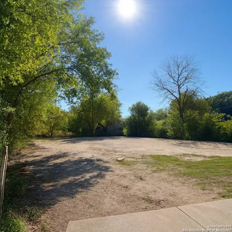a view of a swimming pool with a yard