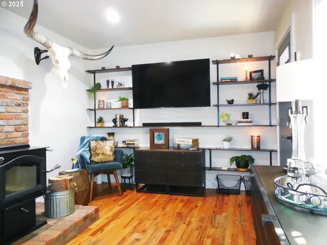 a living room with fireplace furniture and a flat screen tv