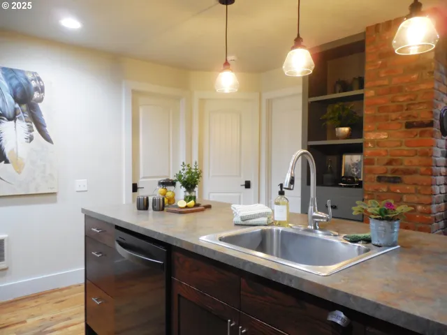 a kitchen with a sink and chandelier