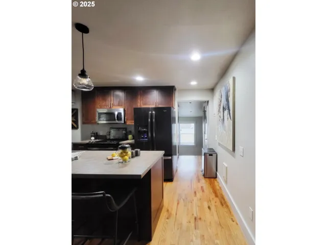 a kitchen with stainless steel appliances a sink stove and refrigerator