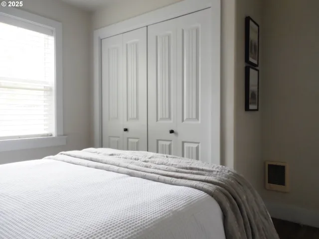 a bedroom with a bed and a window