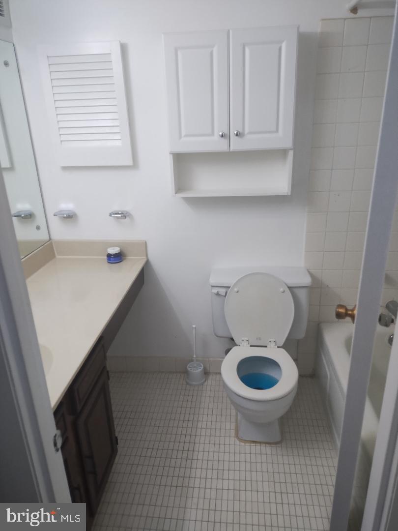2141 P Street Northwest, Unit 202 Washington, DC 20037 - Photo 17 of 30 a bathroom with a toilet a sink and a window