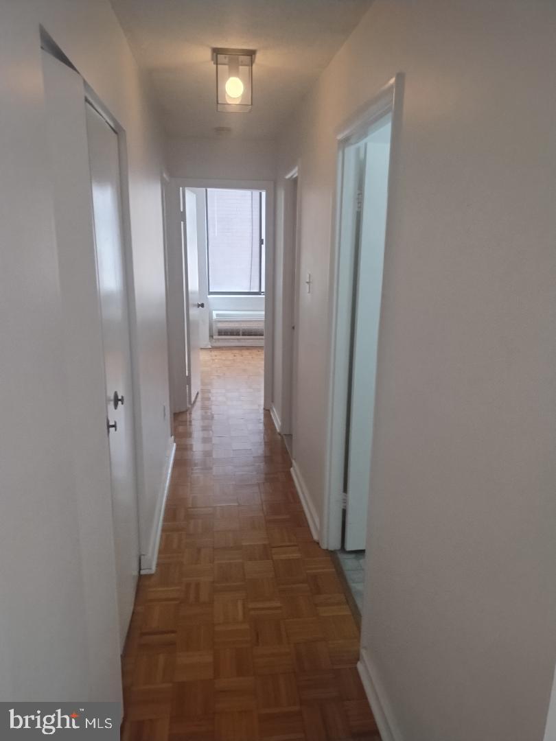 2141 P Street Northwest, Unit 202 Washington, DC 20037 - Photo 20 of 30 a view of a hallway with wooden floor