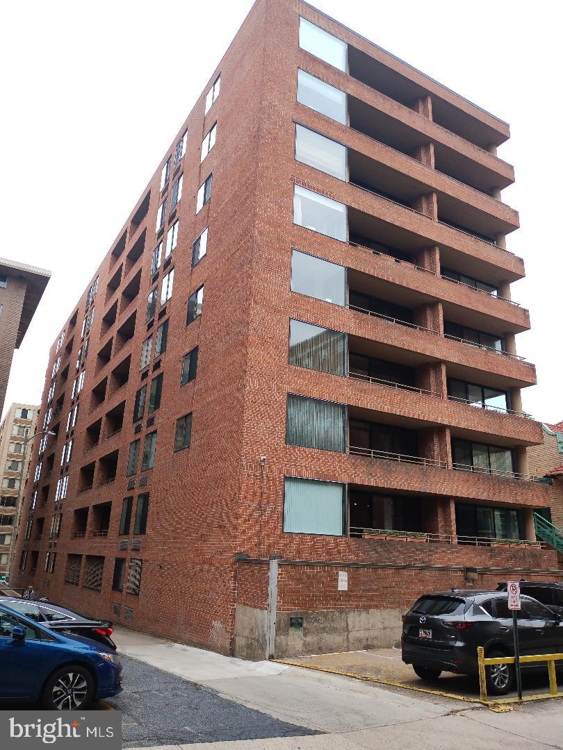 2141 P Street Northwest, Unit 202 Washington, DC 20037 - Photo 26 of 30 a view of a buildings with car parked